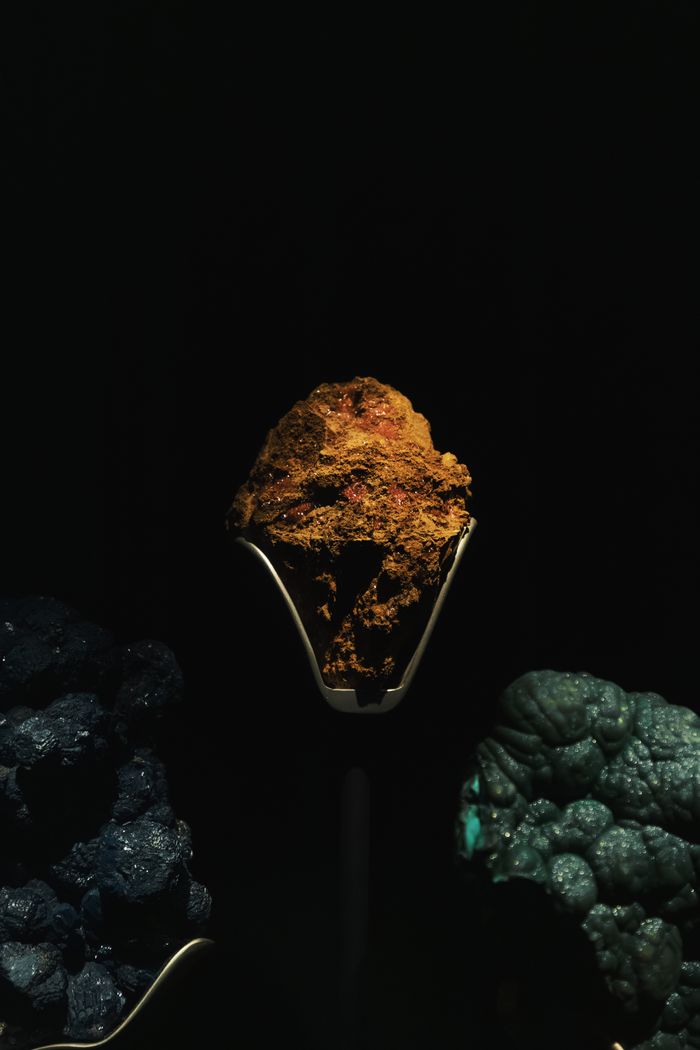A striking display of minerals and rocks with dramatic lighting and rich textures.